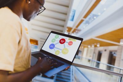 Undergraduate student looking at an economics model on a laptop, Monica Partridge building