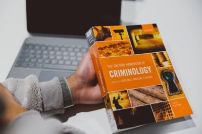 Undergraduate student reading a criminology book