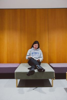 Undergraduate student reading a textbook in the Monica Partridge Building