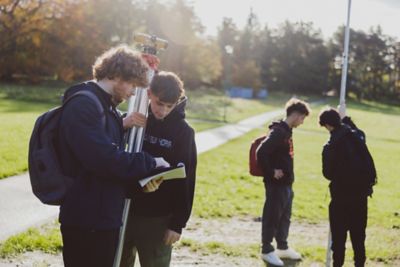 Undergraduate students using surveying equipment on the Downs, University Park