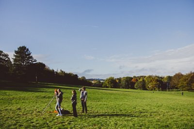 Undergraduate students using surveying equipment on the Downs