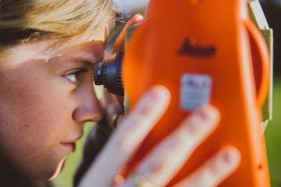 Undergraduate students using surveying equipment on the Downs, University Park