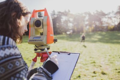 Undergraduate students using surveying equipment on the Downs, University Park