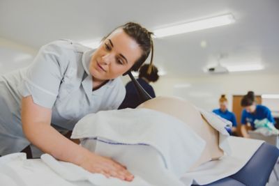 Undergraduate students practicing auscultation in the Health sciences QMC Clinical Skills suite