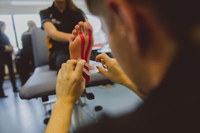 Apply physio tape to a foot