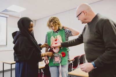 Undergraduate students interacting with internal organs tabard for health promotion group discussion