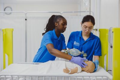 Undergraduate students practicing manual resuscitation on a paediatric simulator