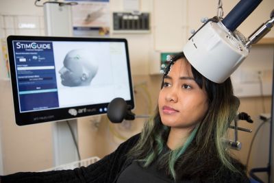 Clinician Joseph Stone demonstrating Transcranial Magnetic Stimulation (TMS) with postgraduate student Anissa Lintang Ramadhani  December 2019Full story can be seen here https://www.nottingham.ac.uk/research/beacons-of-excellence/precision-imaging/our-projects/brightmind/brightmind.aspx