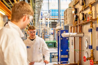 Undergraduate Chemical and Environmental Engineering students working with a heat place exchanger