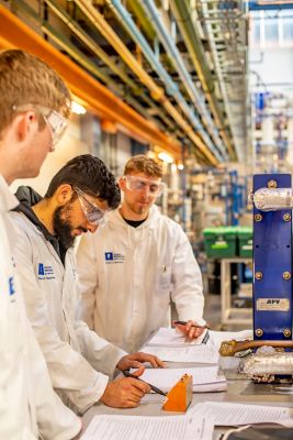 Undergraduate Chemical and Environmental Engineering working with a heat place exchanger