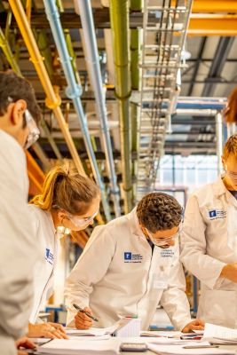 Undergraduate Chemical Engineering students testing water friction losses across piping