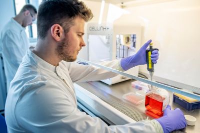 Postgraduate student Jordan Hill at Cellink INKredible Extrusion Bioprinter with postgraduate student Kristian Plender in the background