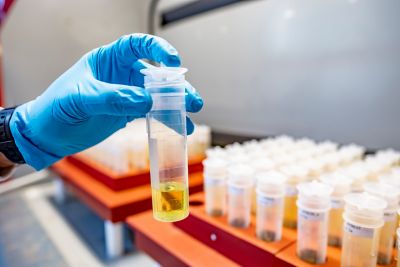 Technical Specialist Saul Vazquez Reina preparing samples on the hot plate in Acid digestion lab wearing safety goggles.