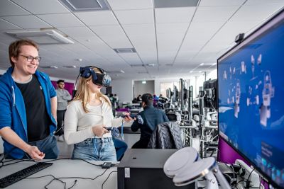 Teaching Assistant David Dewar and undergraduate student Raphaella Shailos building a formula student car using a VR headset in Pope Building CO1, EEE Collaborative Teaching and Project Lab 2