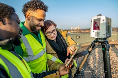 PhD student Anna Klimkowskia and PGT students Adewale Fazaya and Luke Taylor using a Total Station to capture their surroundings on the Geospatial Building roof