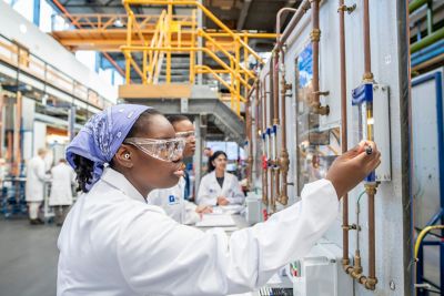 Undergraduate Chemical and Environmental Engineering student inspecting a heat and mass balance around recycle loop