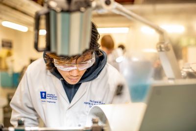 Undergraduate student turning metal on a centre lathe