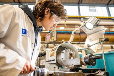 University student turning metal on a centre lathe