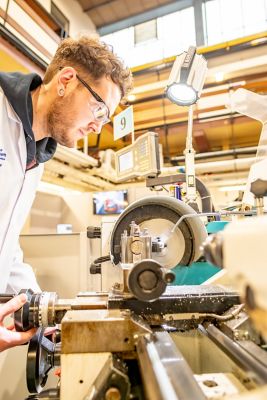 University student turning metal on a centre lathe